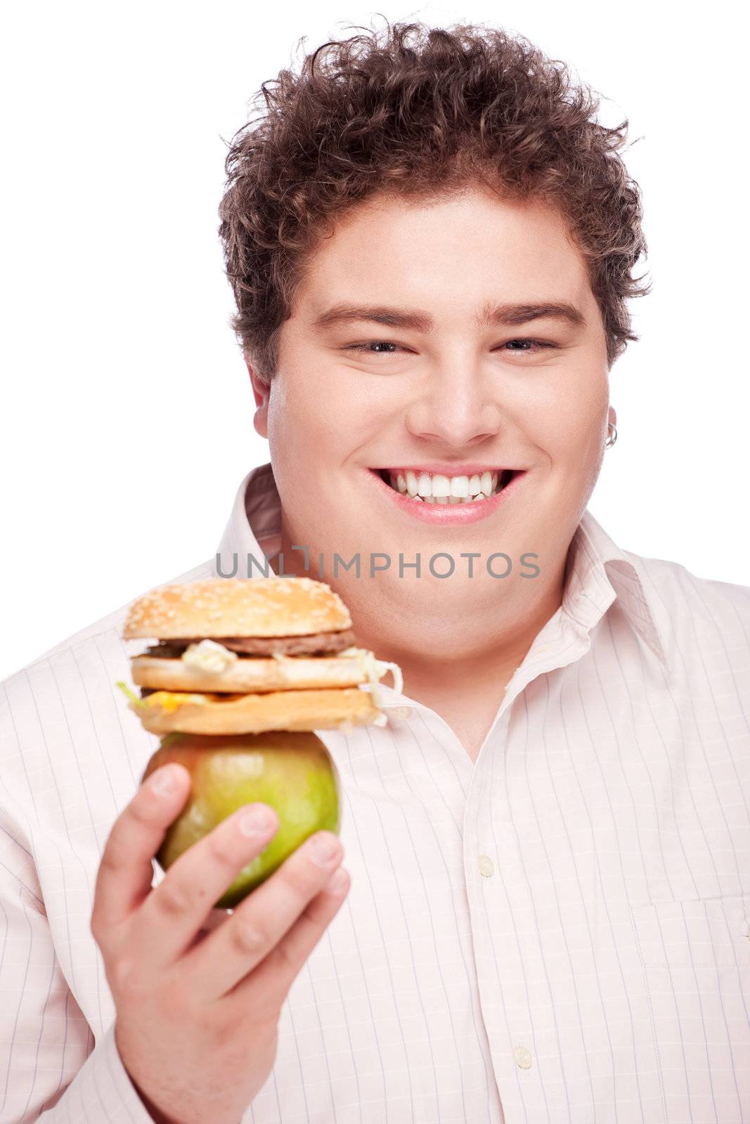 Young chubby man holding apple and hamburger, isolated on white