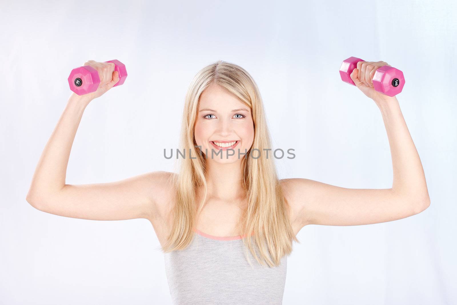 smiled woman doing fitness exercises by imarin