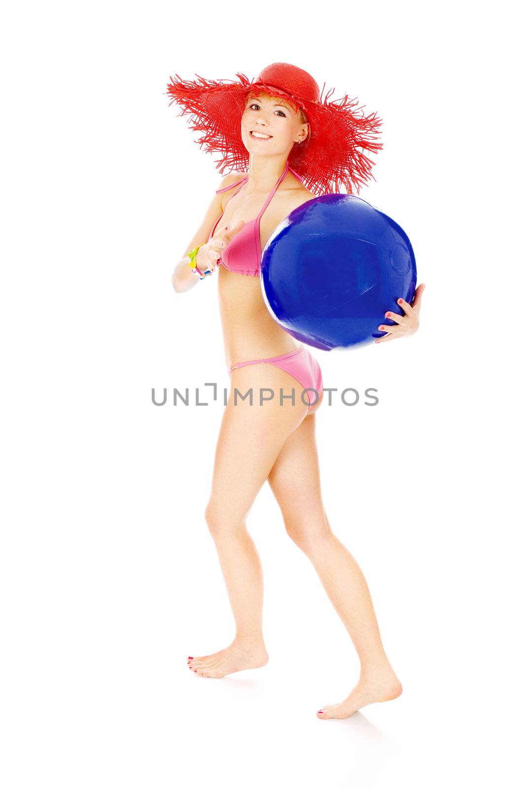 Young girl in bikini runing and hold blue ball, isolated on white background