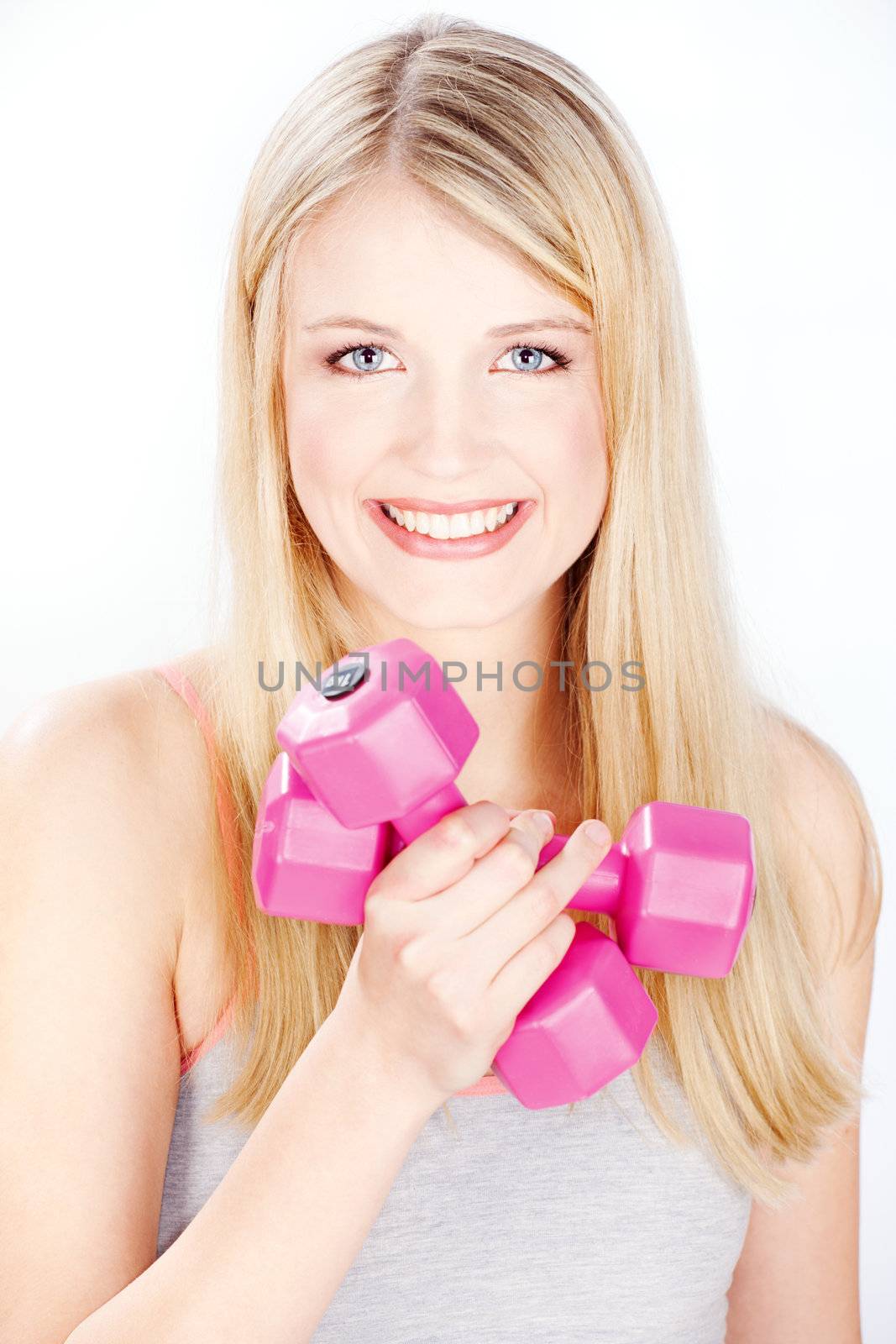 Young smiled woman holding two weights in one hand