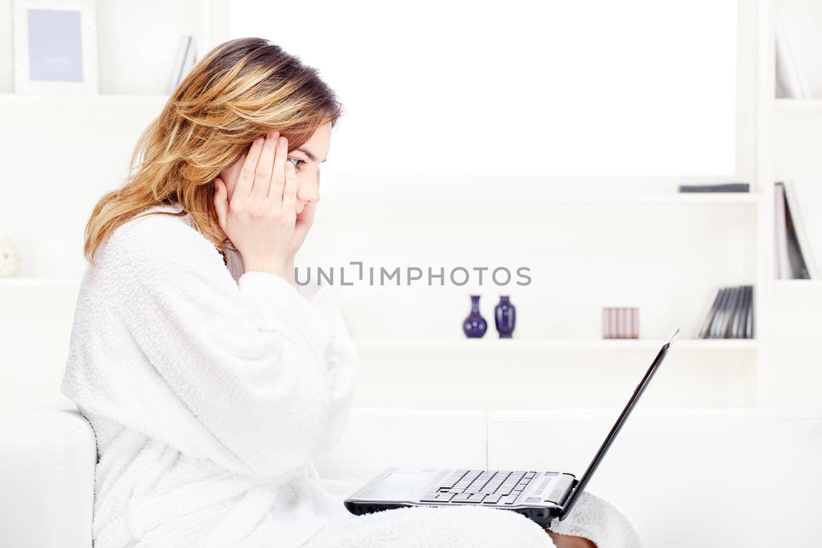 teenage girl at home in bathrobe chatting on computer