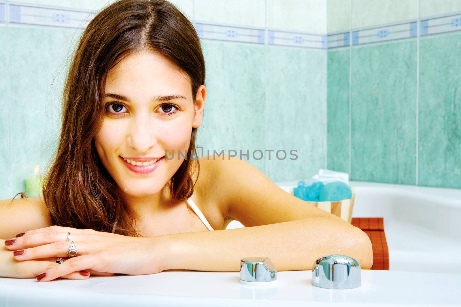 Young brunette woman in the bathtub