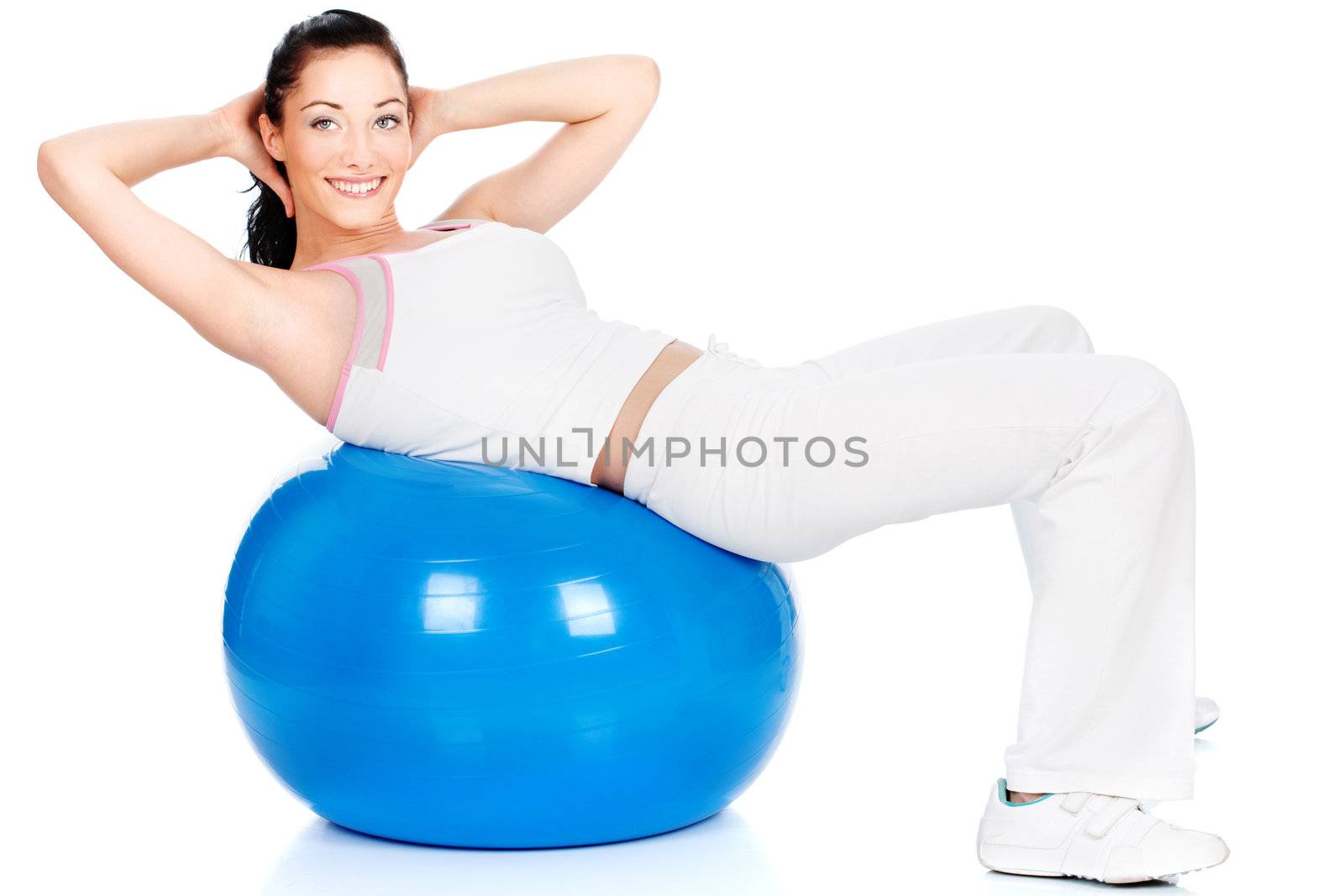 Happy girl doing exercise on the big blue ball, isolated on white