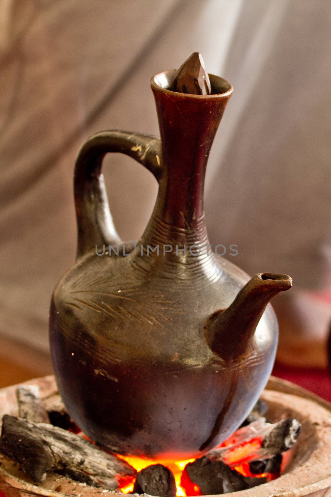 Making coffee the traditional way using coal with a Jebena