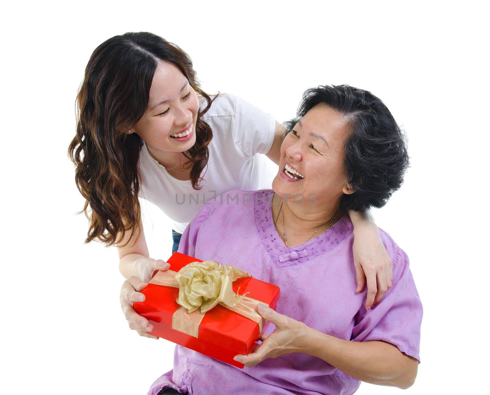 Happy Mixed race Asian mother receiving present from her daughter