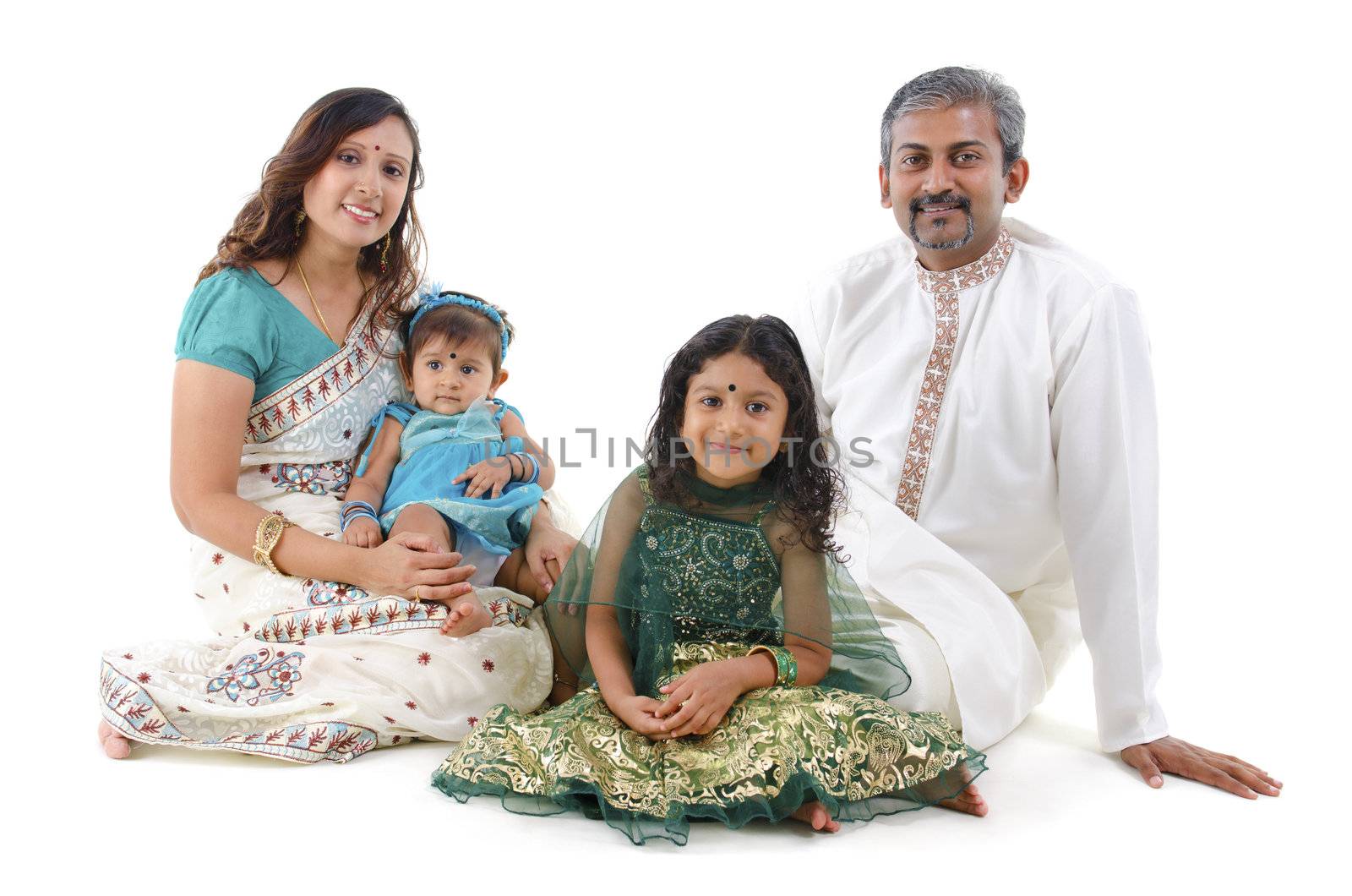 Happy Indian family sitting on white background