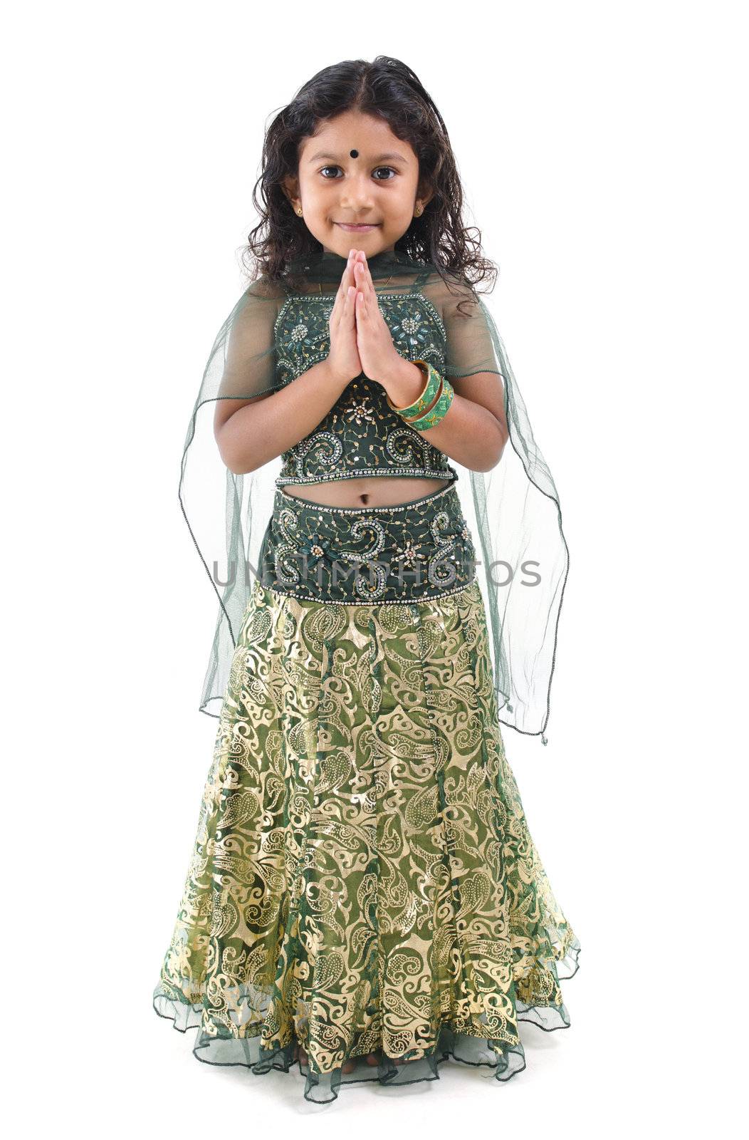 Cute little Indian girl in a greeting pose, isolated white background