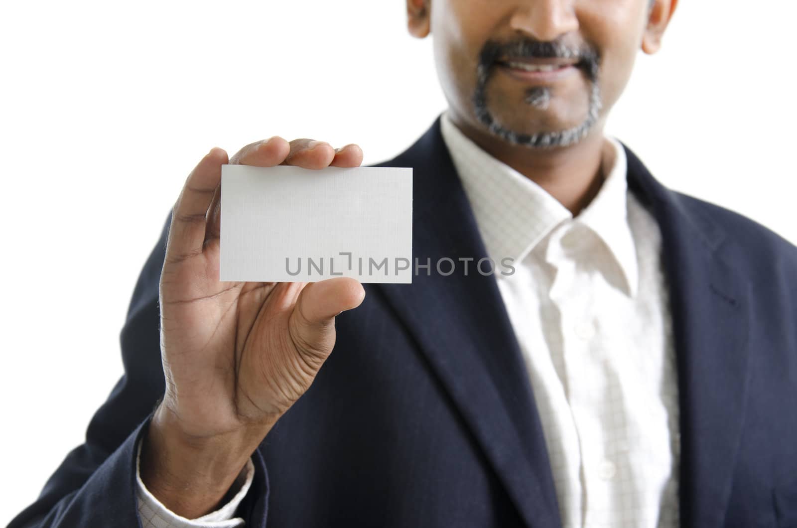 Mature Asian Indian businessman holding business card, focus on hand over white background
