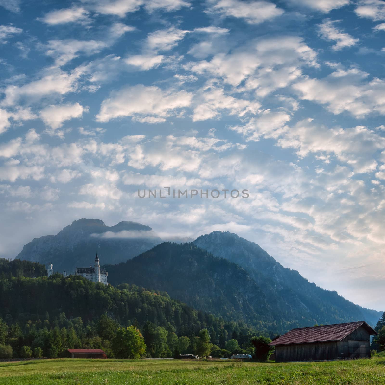 Mountain landscape with castle on the top and beautiful sky on background