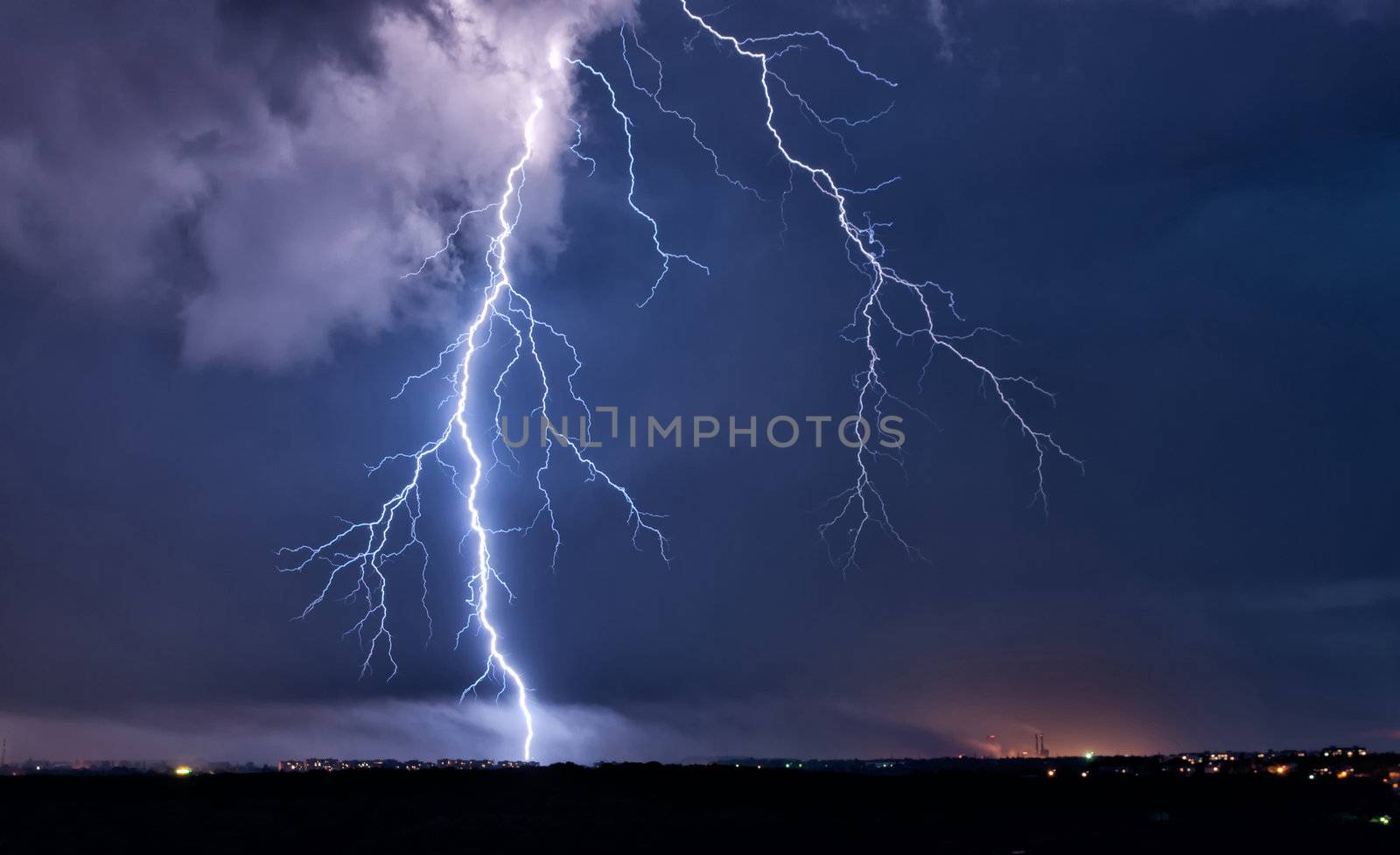 Big lightning in the stormy sky over a city