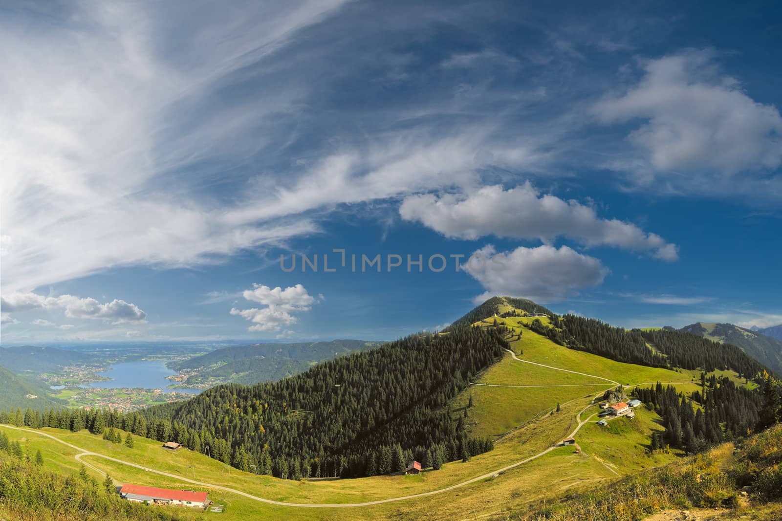 Beautiful panorama Alps mountains with lake in valley and clouds on background