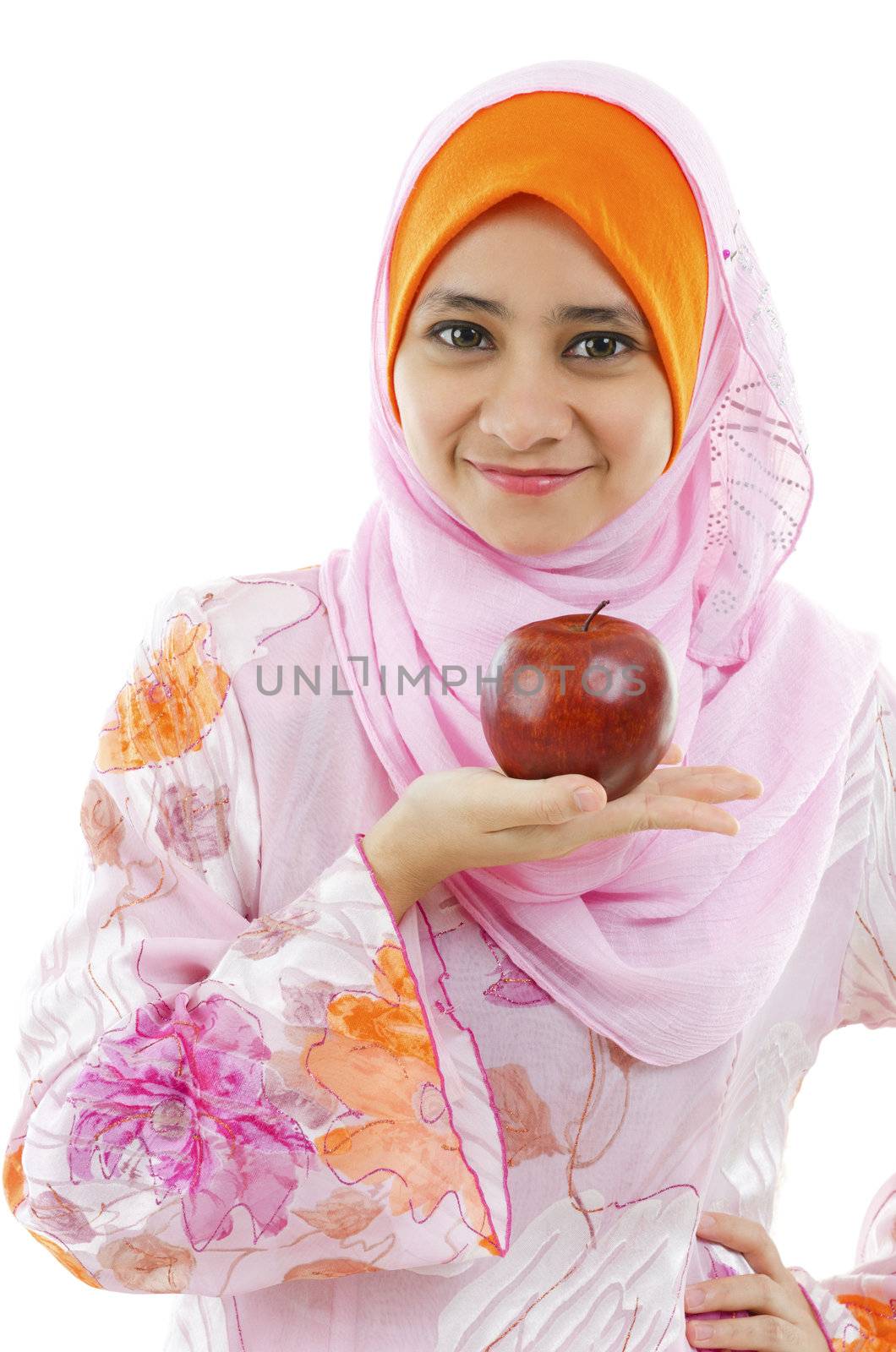 Young Muslim woman holding an apple on palm, healthy eating concept