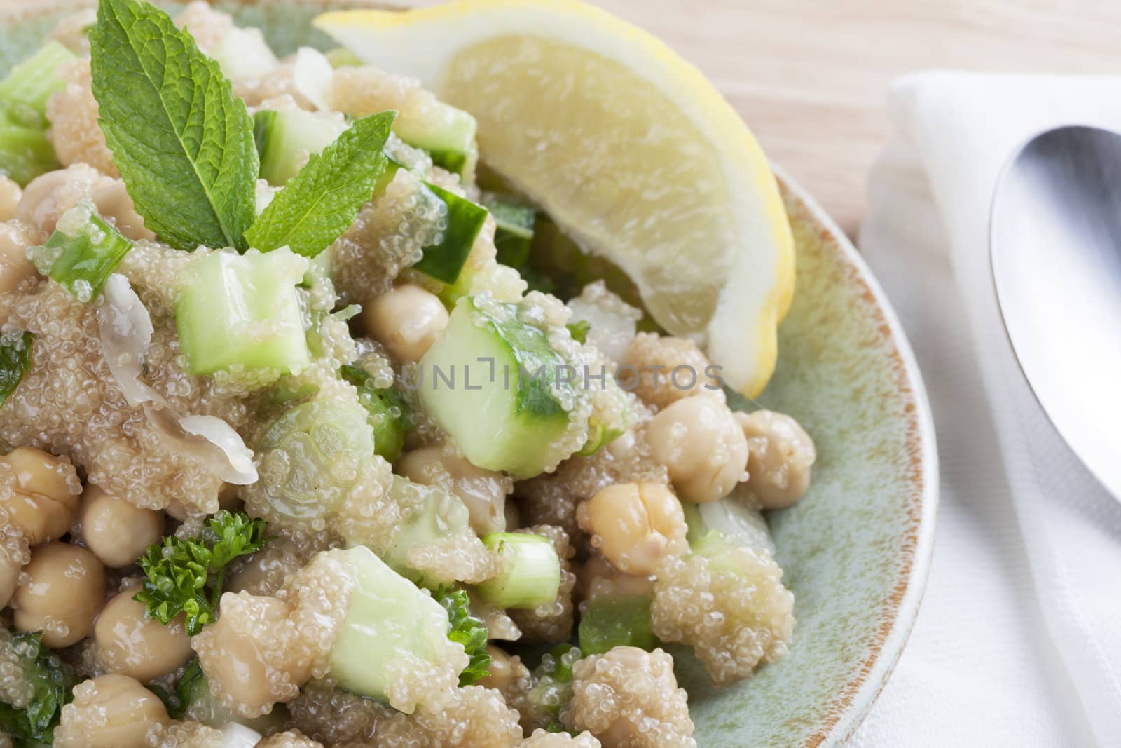 Cooked amaranth seeds with cucumber chickpeas and mint in a tabouli style vegan salad.