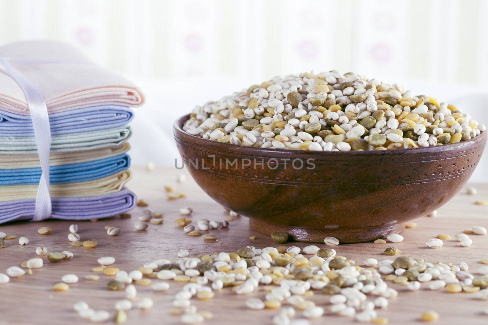 Bowl of healthy mixture of barley and green and yellow lentils.