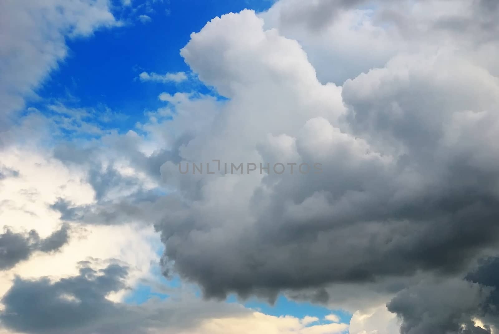 Cloudy sky full of deep grey thunder clouds on the sunset