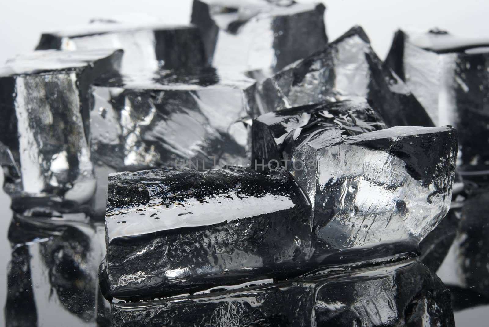 Clear ice cubes close-up. Isolated on light background