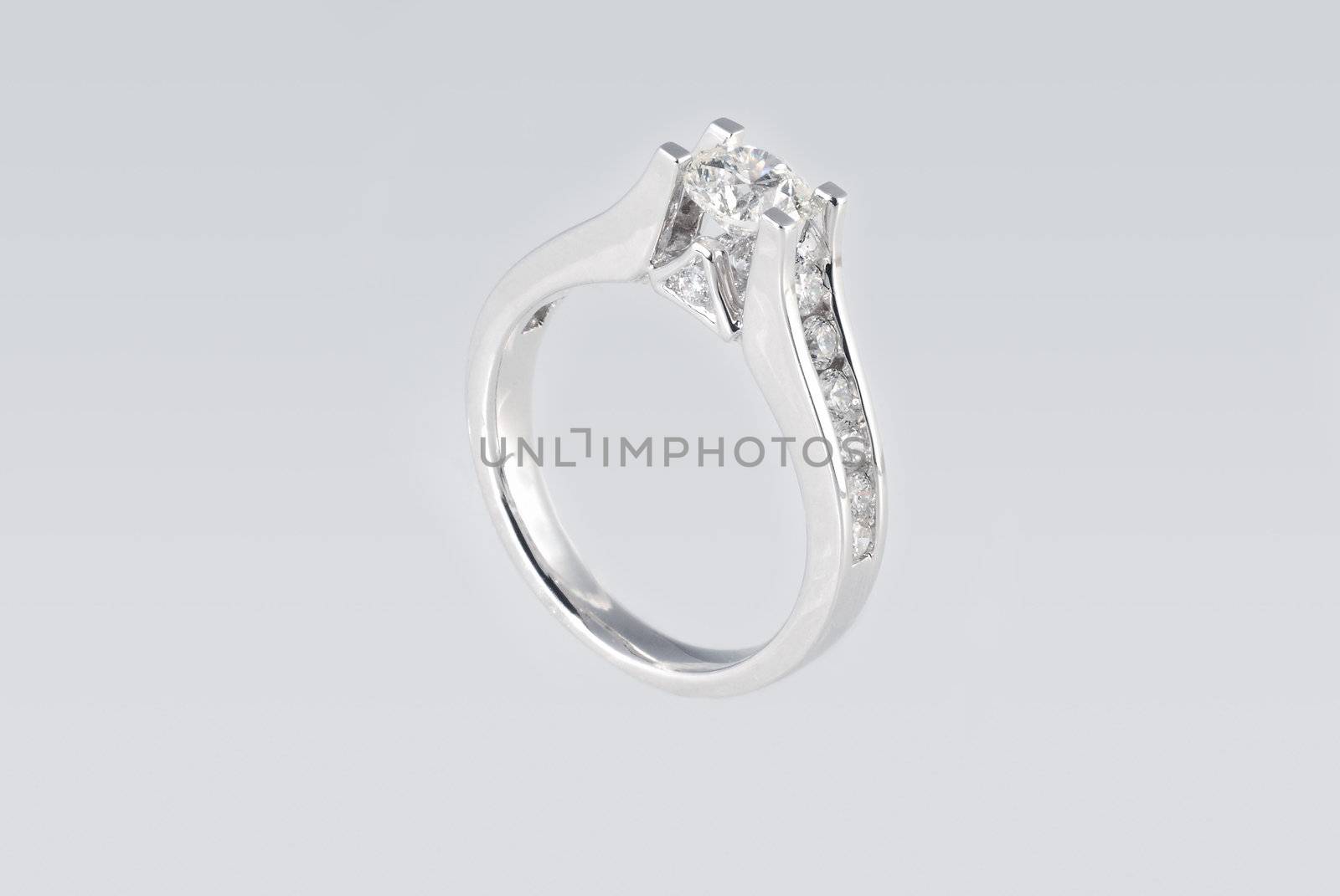 Platinum ring with diamonds over white background