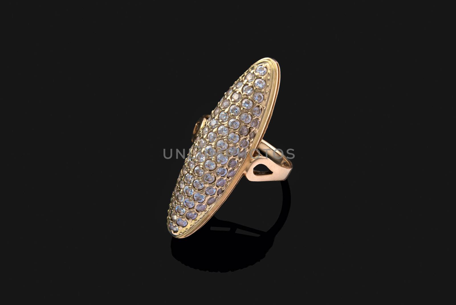 Golden ring with diamonds over black background