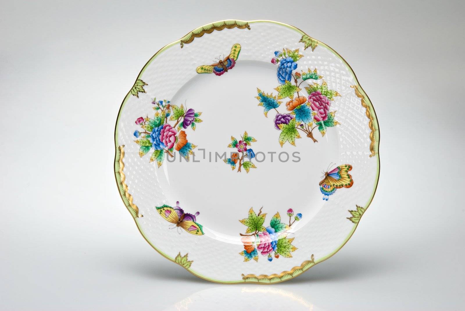 Hand-painted empty dinner plate isolated on white 