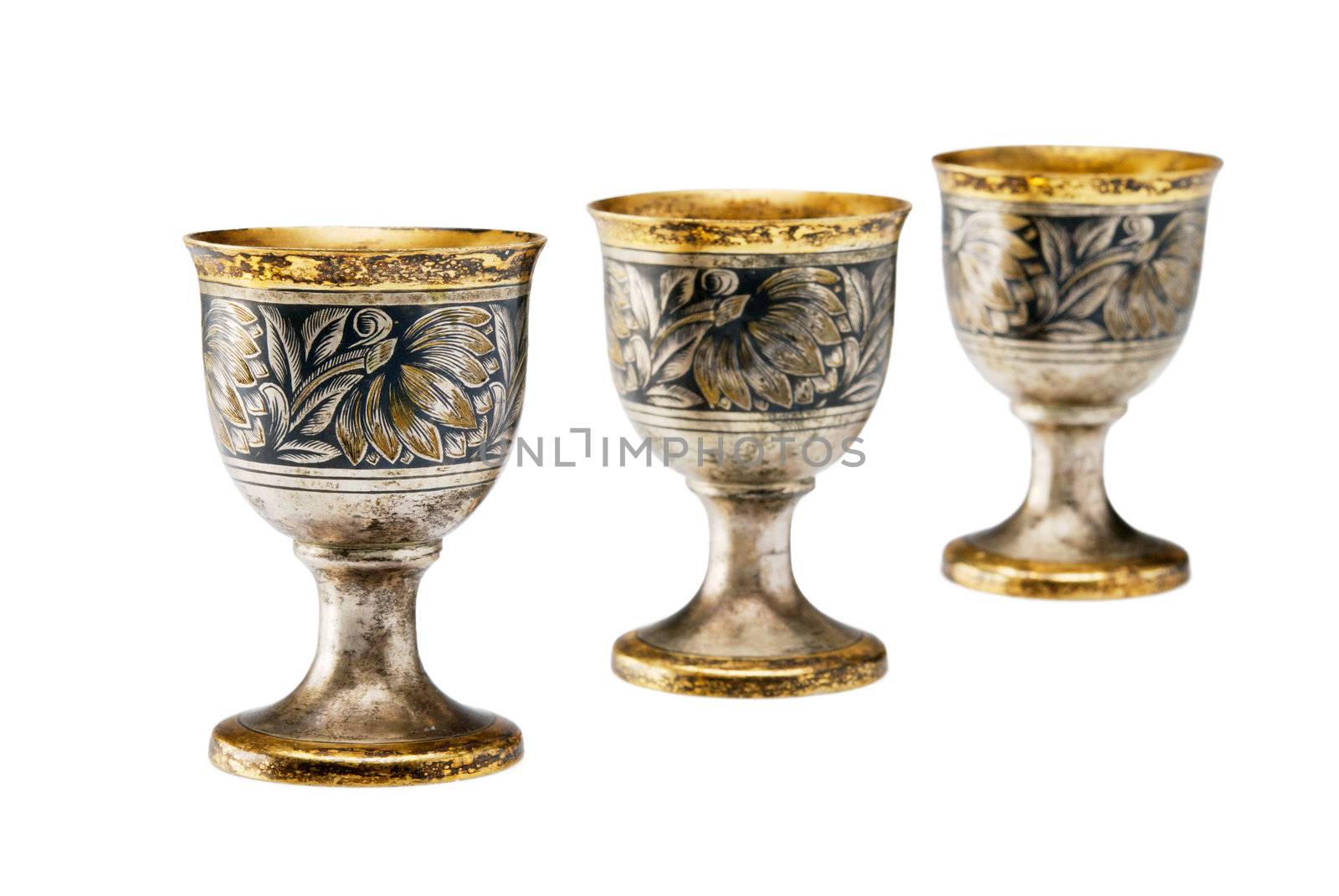 Three ancient wine cup in a line isolated over white background