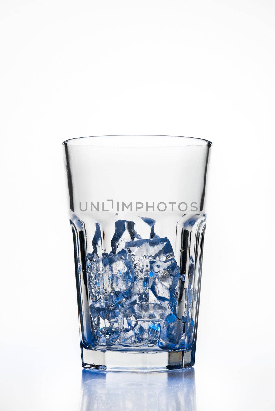 Glass with ice cubes isolated on white background