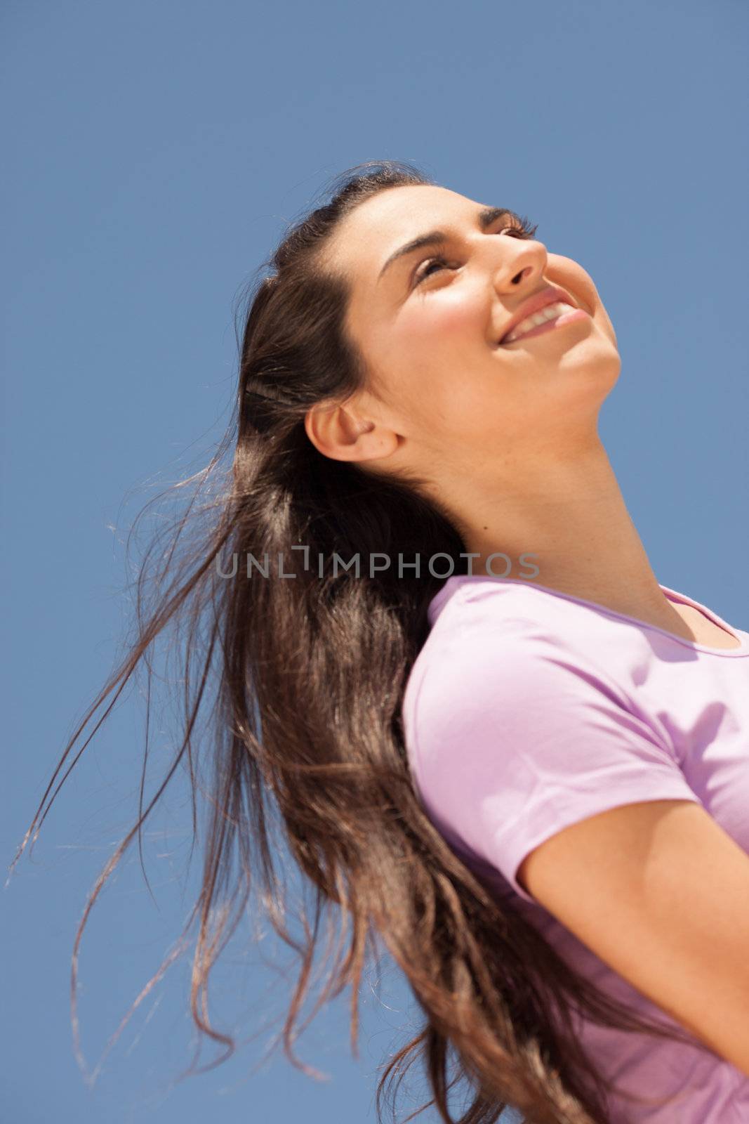Young beautiful woman portrait with sun flare from above