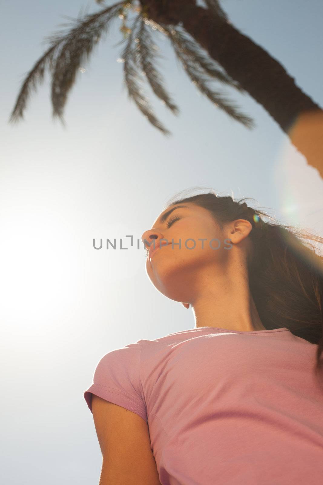 Young beautiful woman portrait with sun flare by Lcrespi