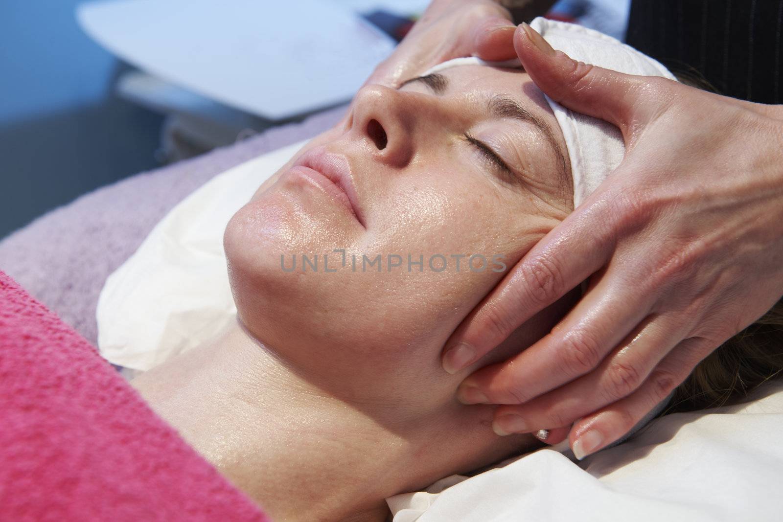 woman having a facial treatment in beauty salon