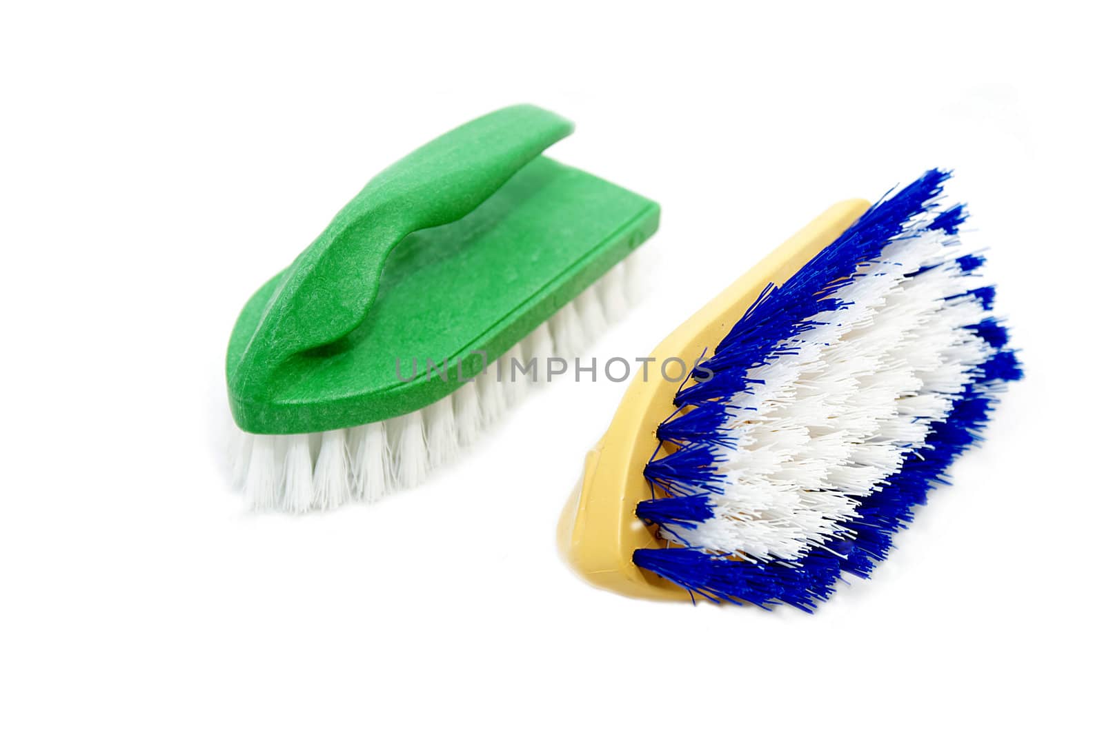 Two small brush for cleaning on a white background