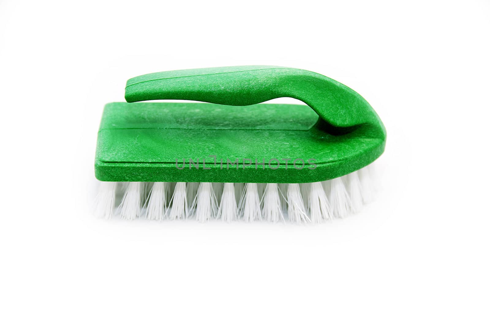 a green cleaning brush on a white background