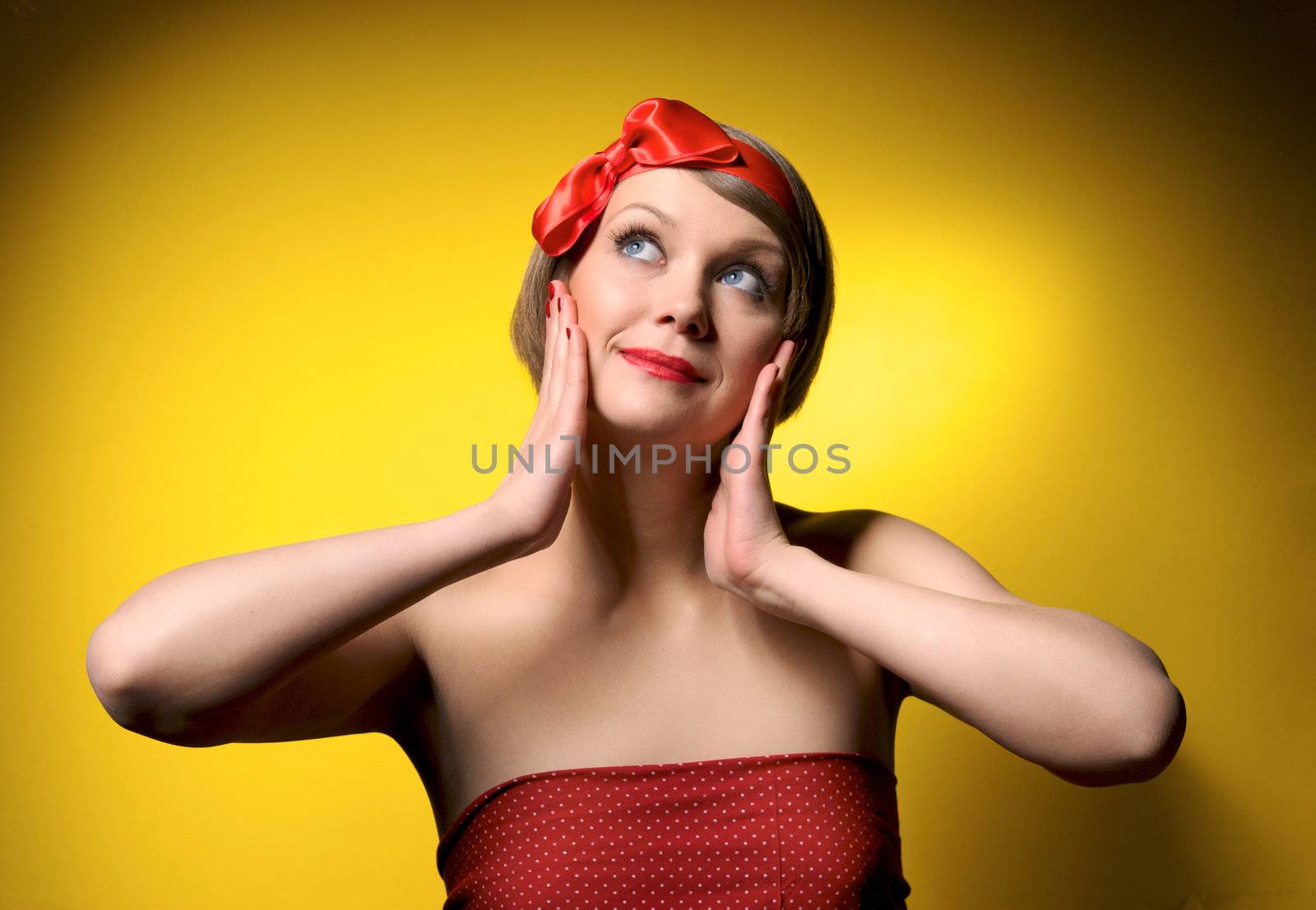 Close-up portrait of smiling beautiful young girl in retro style. Isolated on yellow background