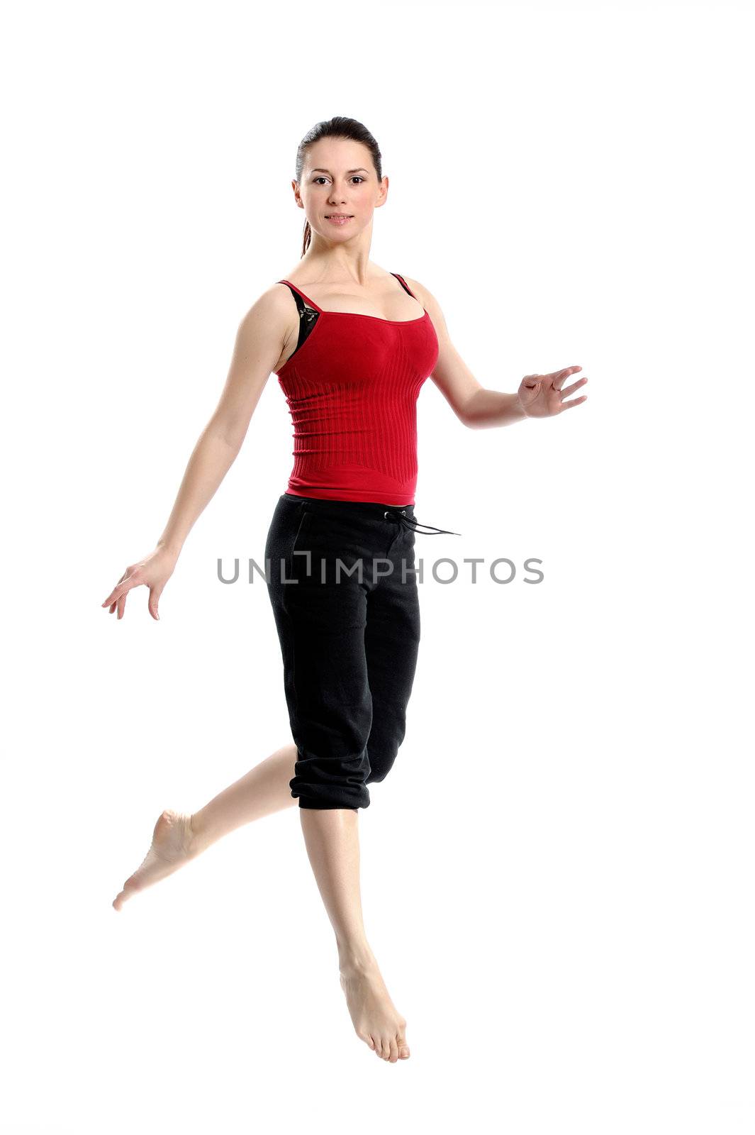 Girl in sportswear jumping jumping over white background. Isolated.