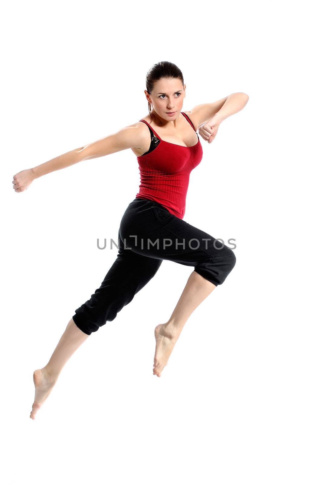 Girl in sportswear jumping jumping over white background. Isolated.