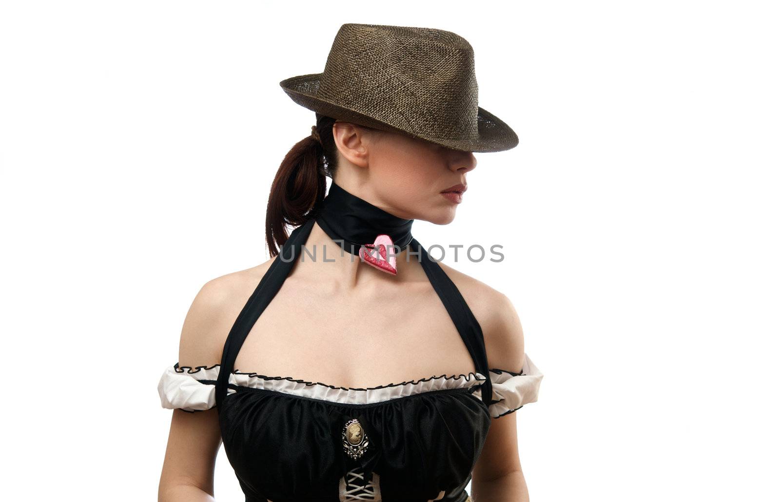 Young woman wearing hat with heart shaped pendent. Isolated on white background
