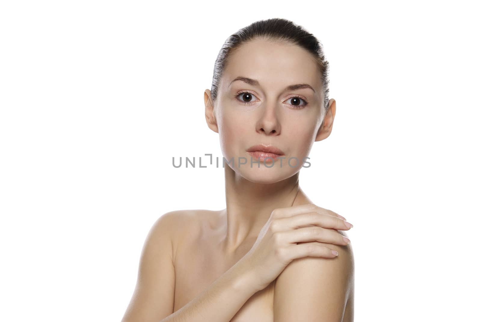 Portrait of young beautiful serene girl with healthy complexion. Isolated on white background