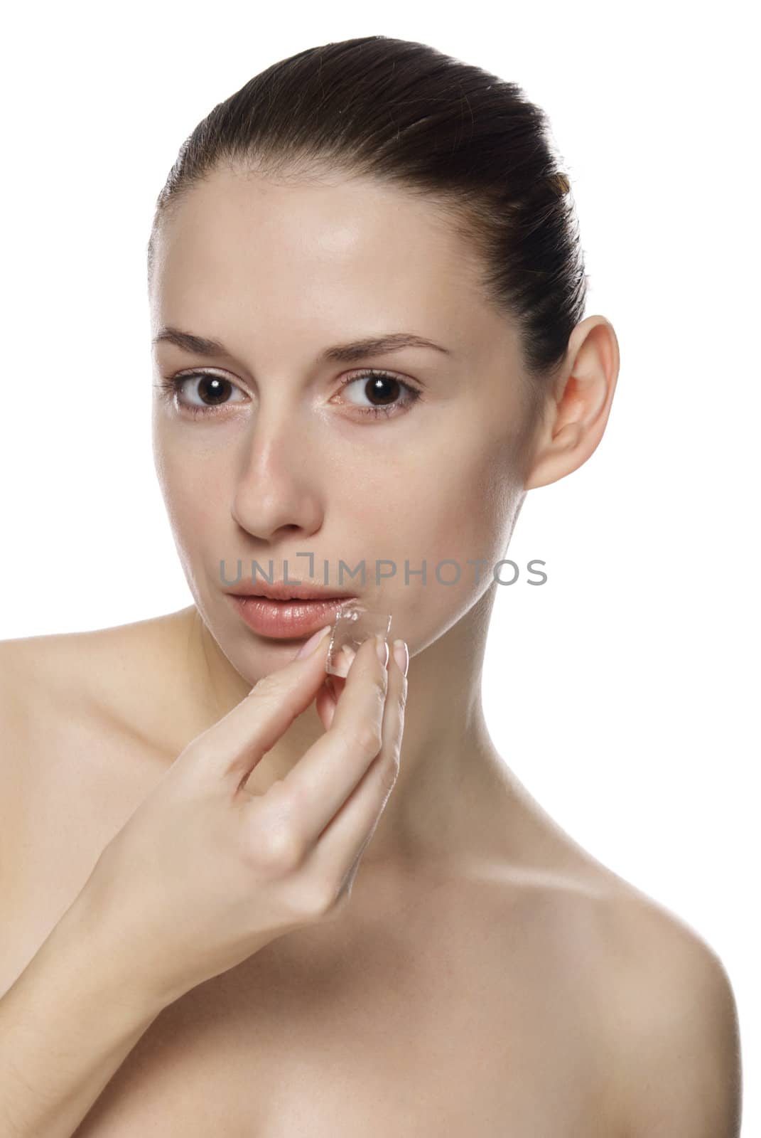 Portrait of young beautiful girl holding ice cube. Isolated on white background