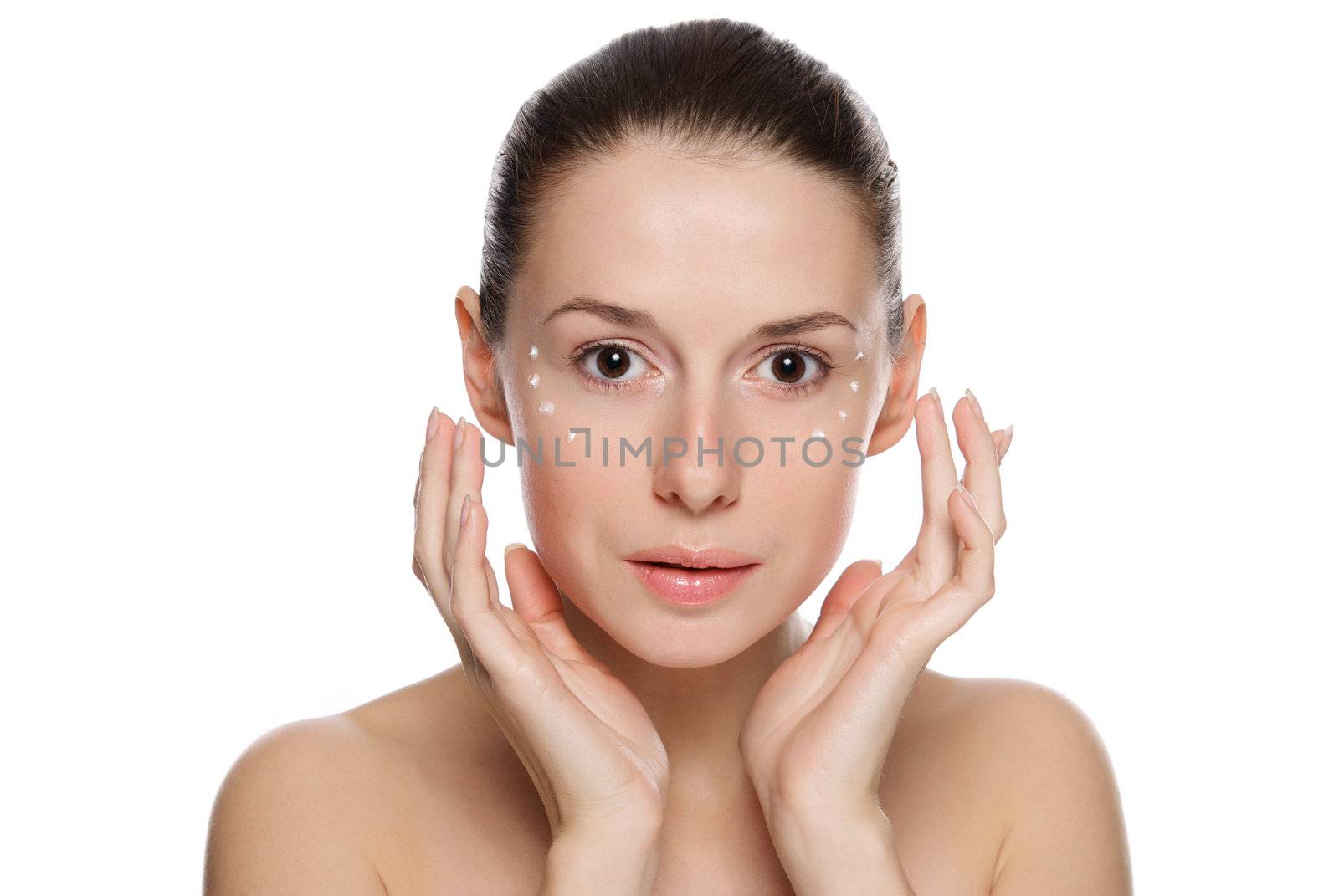 Beautiful sexy woman applying cosmetic cream on skin near eyes by kirs-ua