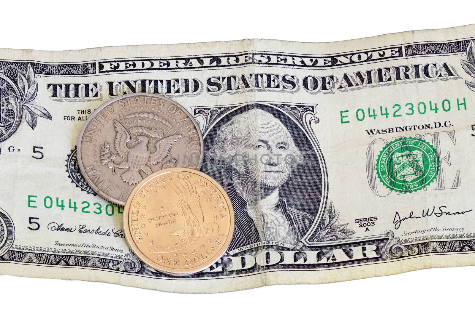 Contrast of the US dollar and half dollar coin with a worn paper bill