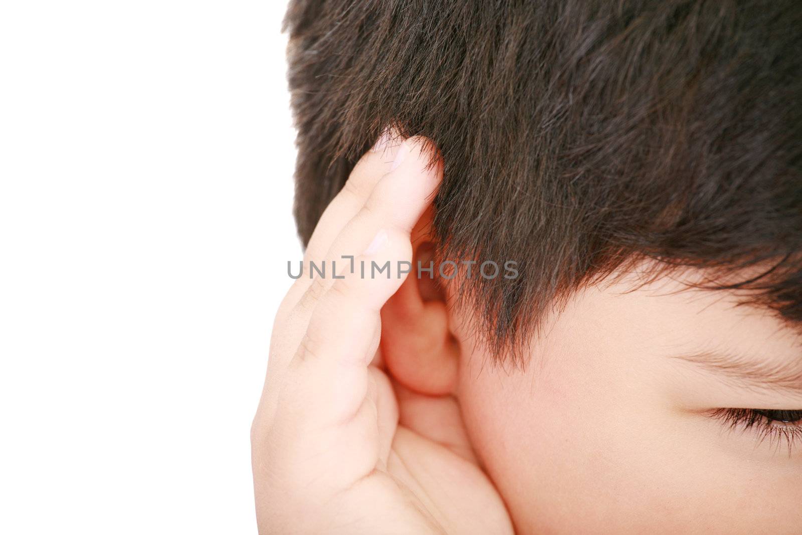 A little boy trying to hearing the sound around him - What did you say?