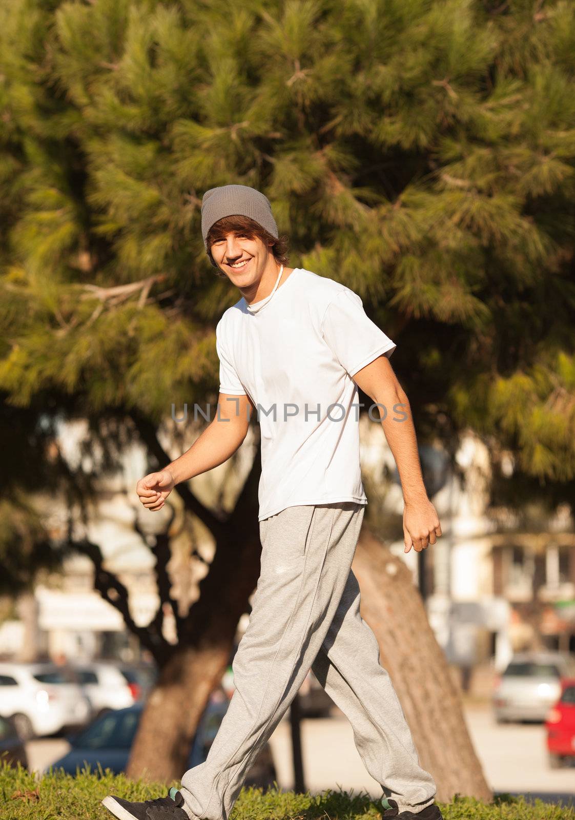 young handsome man jogging in public park by Lcrespi