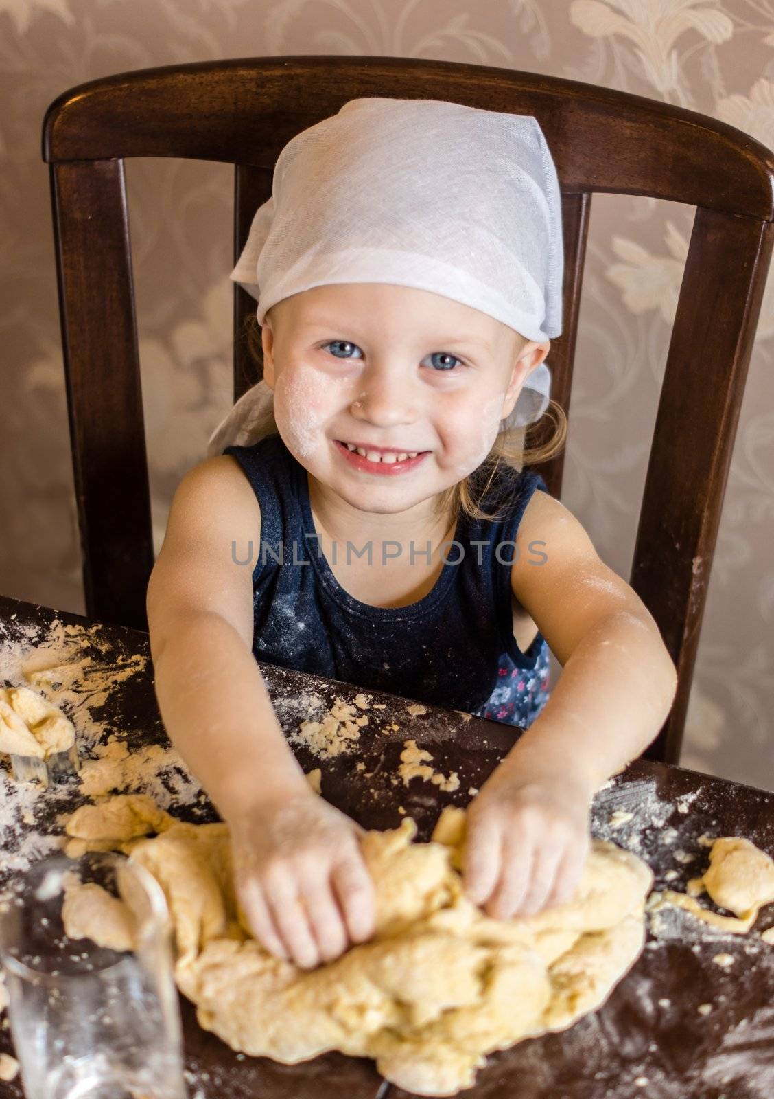 child knead the dough in a kerchief by natochka