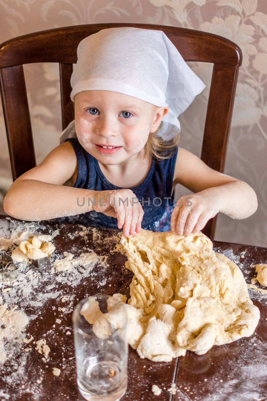 child knead the dough in a kerchief by natochka
