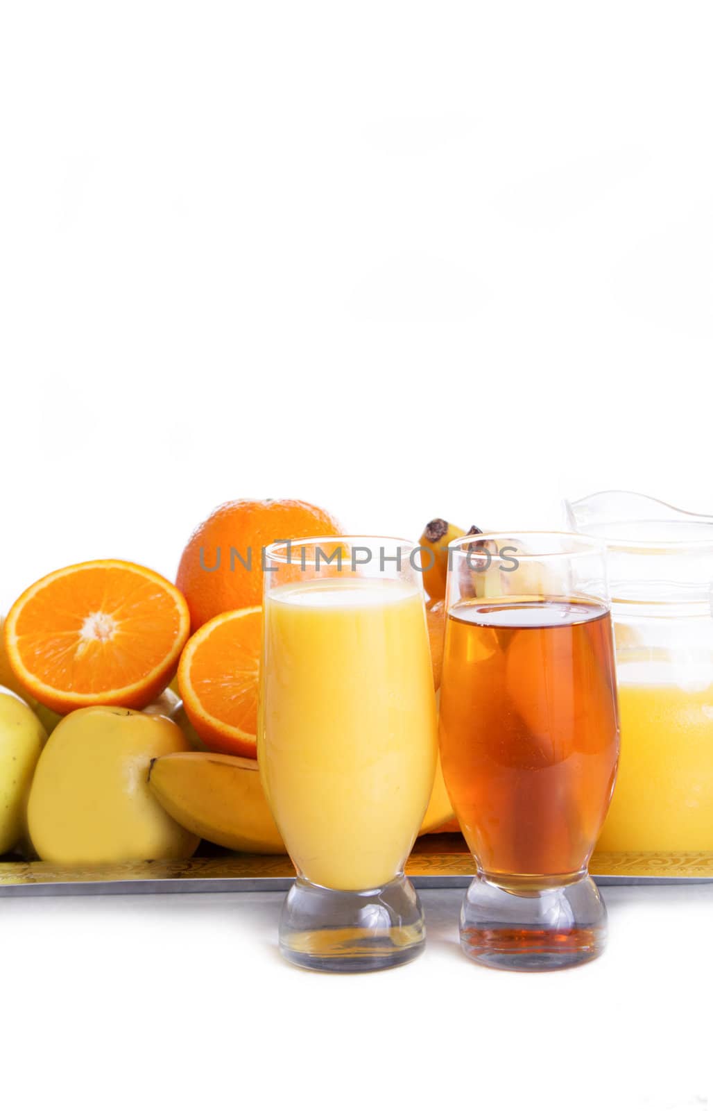 Apple and orange fruits with juice on tray over white