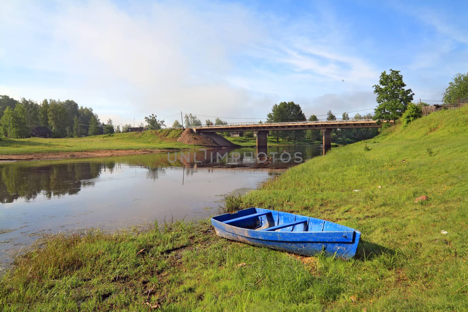 wooden boat on river coast near villages