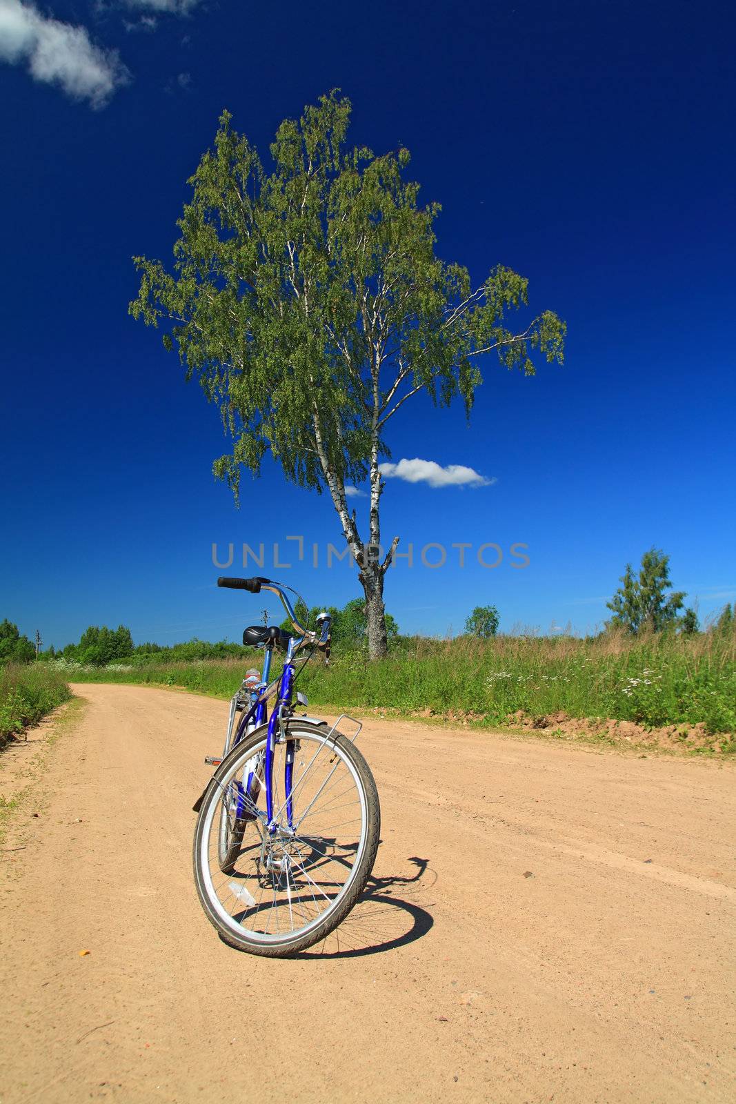 bicycle on rural sandy road by basel101658