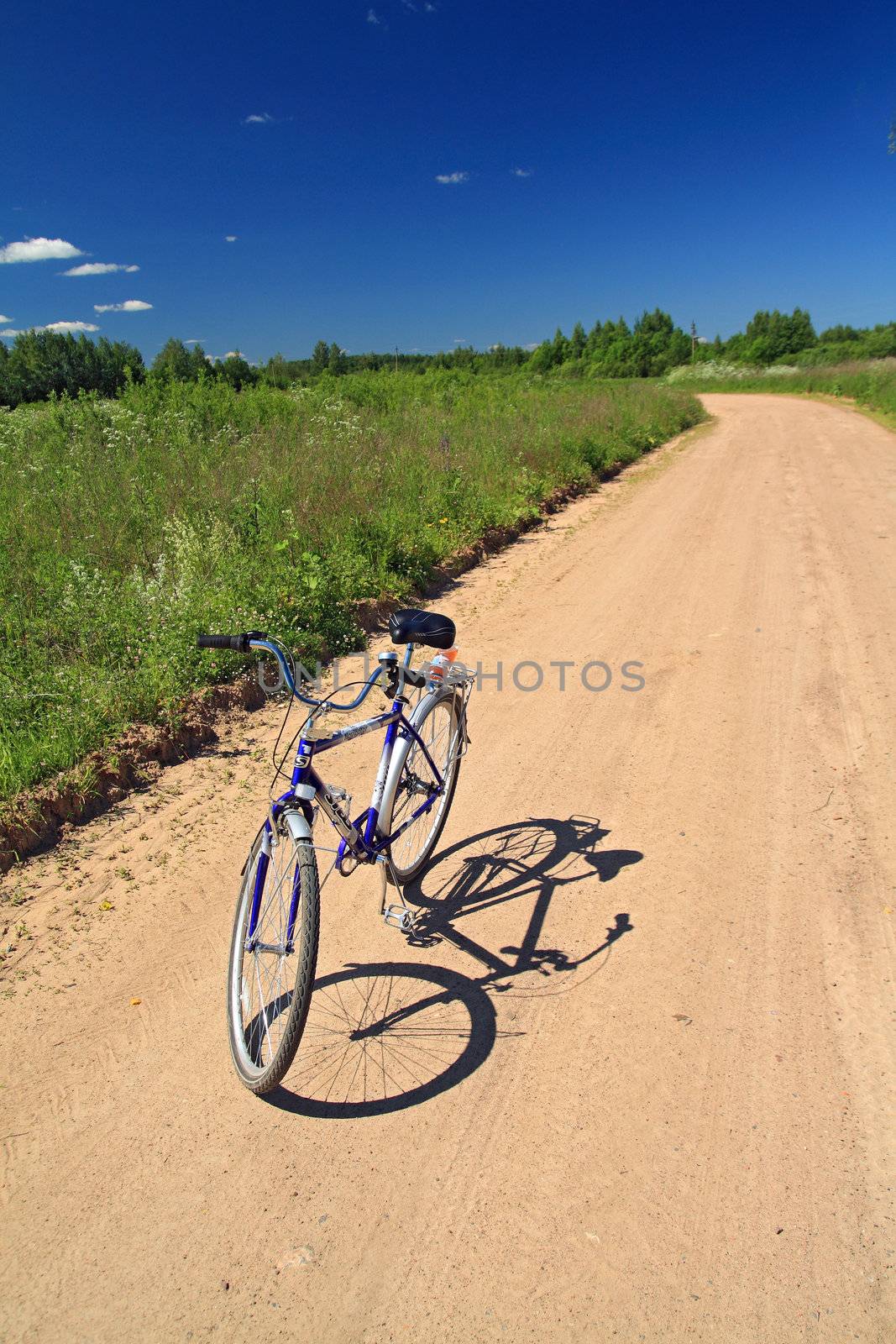 bicycle on sandy rural road by basel101658
