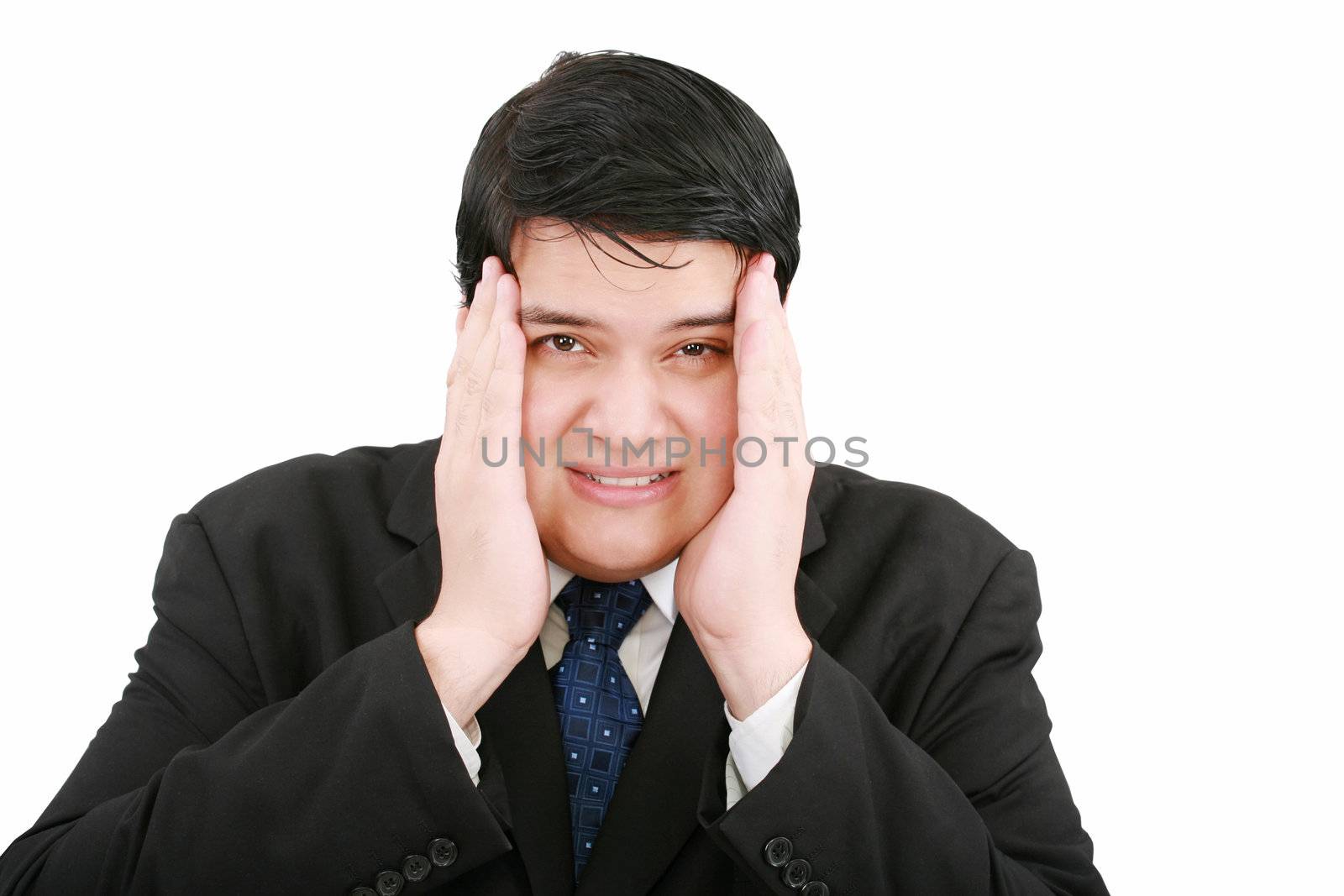 Close-up of a businessman with a migraine holding his temples.