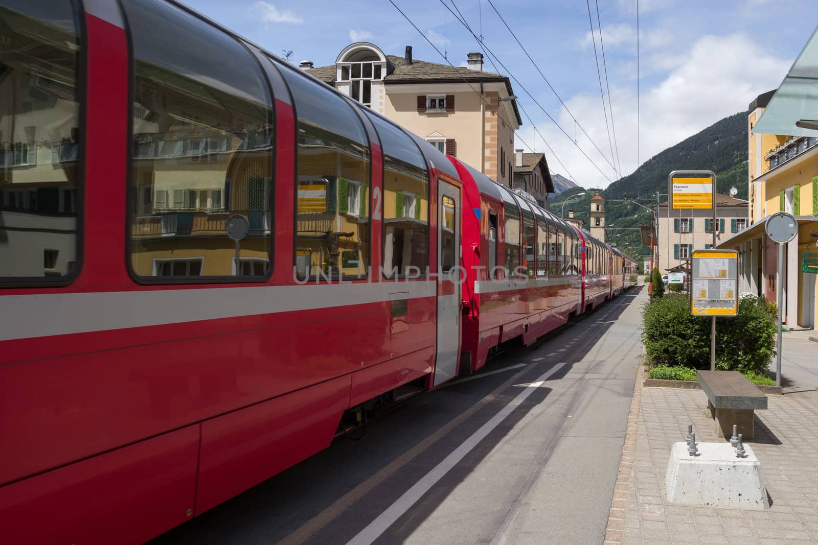 Swiss mountain train Bernina Express in small village La Prese