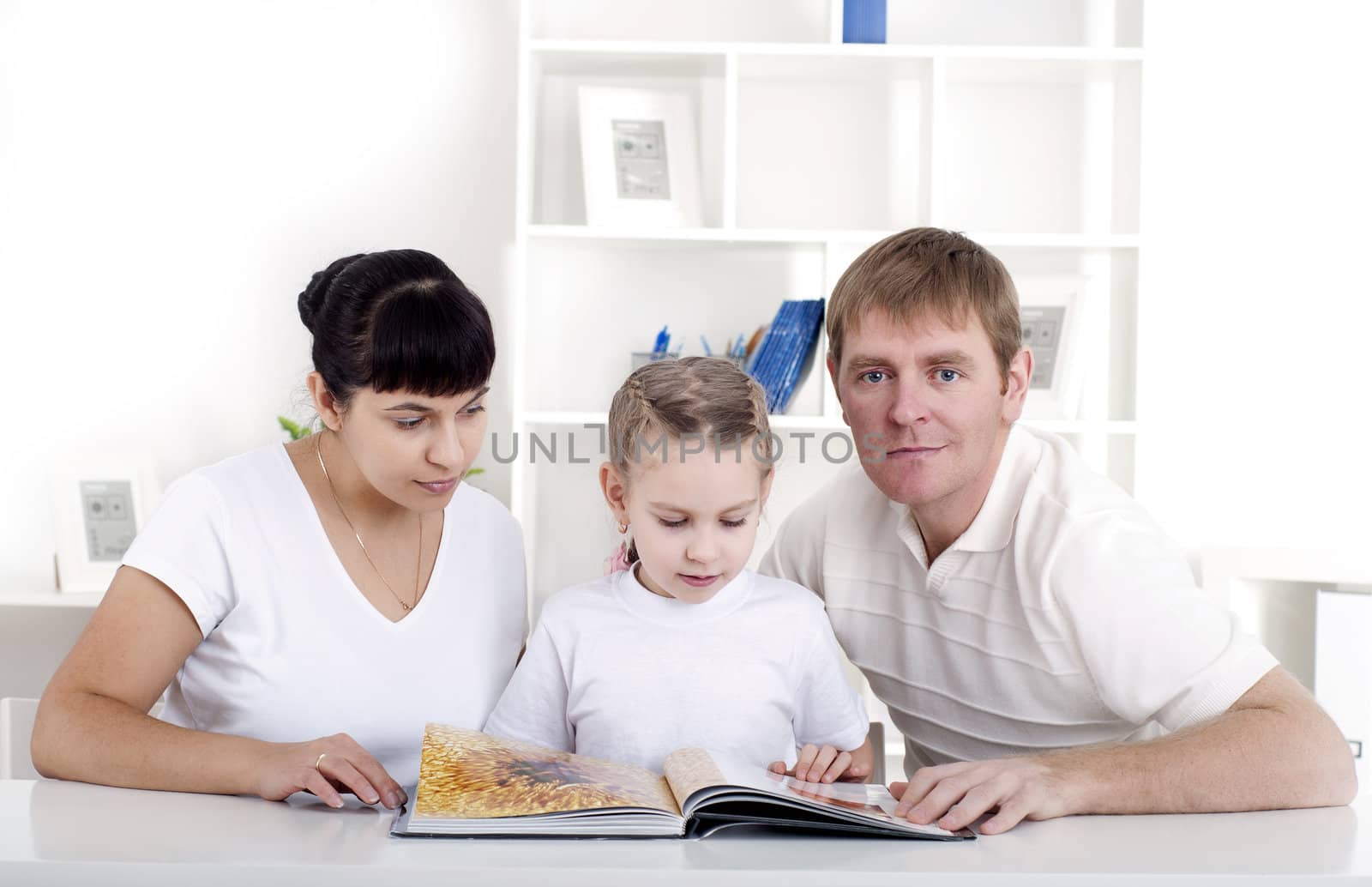 Family reading a book together, a family vacation