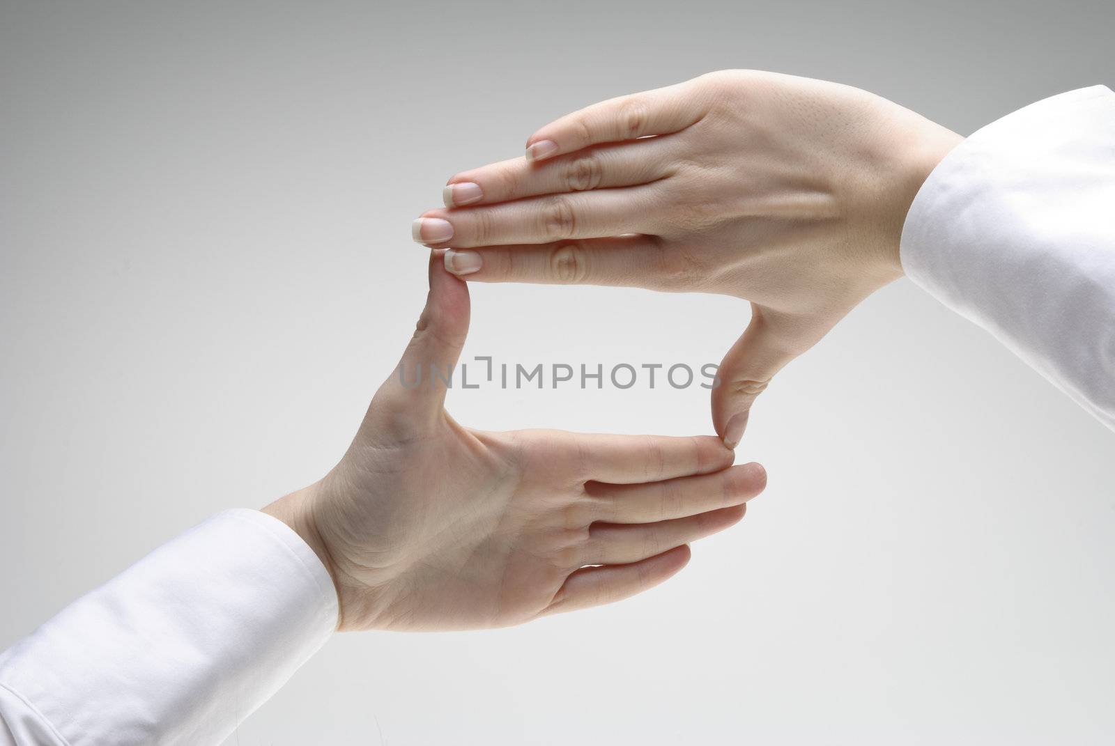 Woman's hand showing crop symbol over light background